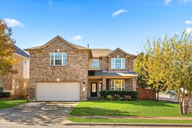 traditional-style home featuring driveway, brick siding, fence, and a front yard