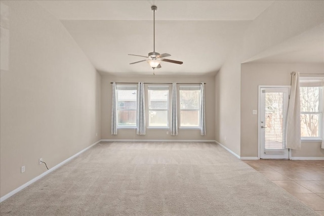 245 Clear Springs Holw, Buda, TX 78610 - tiled empty room with lofted ceiling, a ceiling fan, healthy amount of natural light, baseboards, and carpet