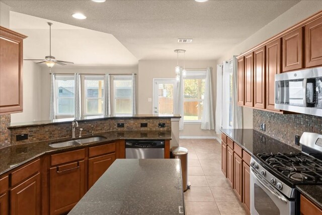 245 Clear Springs Holw, Buda, TX 78610 - kitchen with stainless steel appliances, a sink, a ceiling fan, decorative backsplash, and recessed lighting