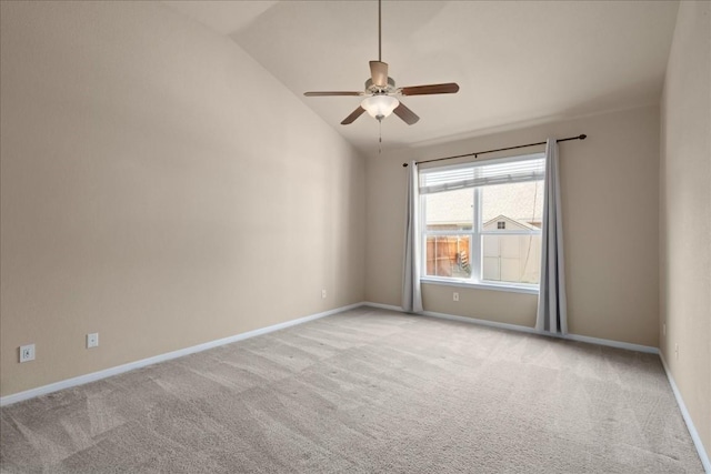 empty room featuring vaulted ceiling, light carpet, a ceiling fan, and baseboards