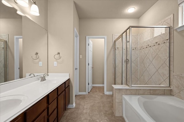 bathroom with a garden tub, a sink, a shower stall, and double vanity