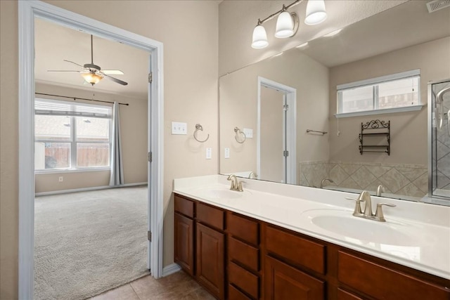 245 Clear Springs Holw, Buda, TX 78610 - bathroom featuring a ceiling fan, double vanity, tile patterned flooring, and a shower