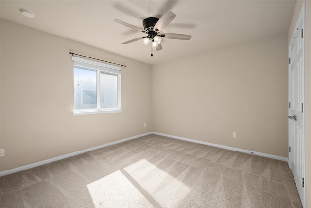 unfurnished room featuring light carpet, ceiling fan, and baseboards