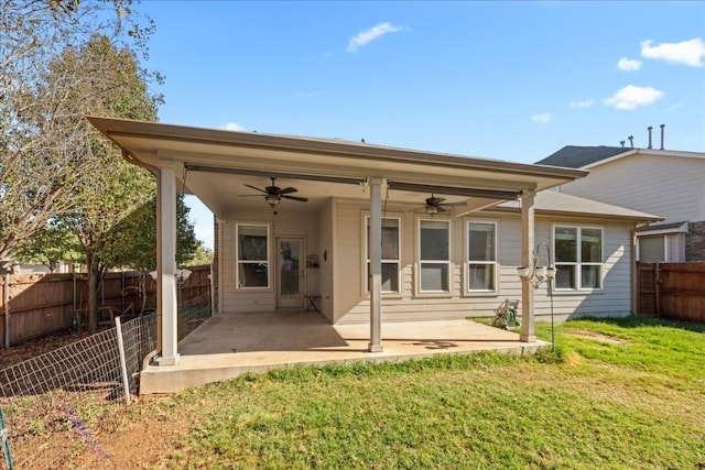 back of house featuring a patio, ceiling fan, and a lawn