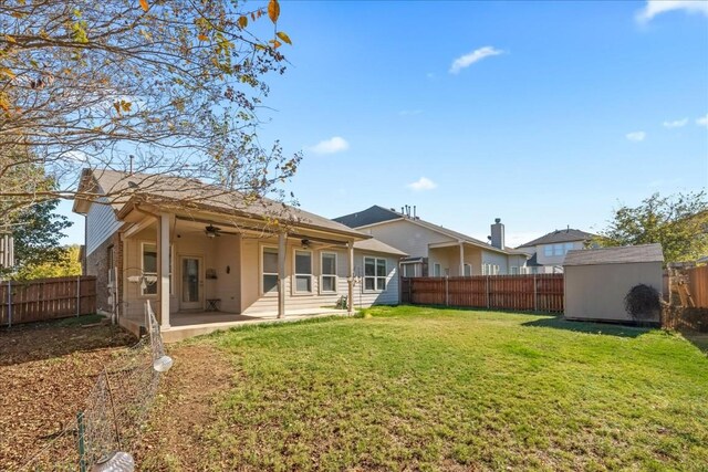 rear view of house featuring a lawn, ceiling fan, and a patio