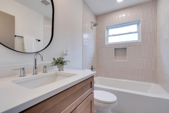 full bathroom featuring vanity, toilet, and tiled shower / bath