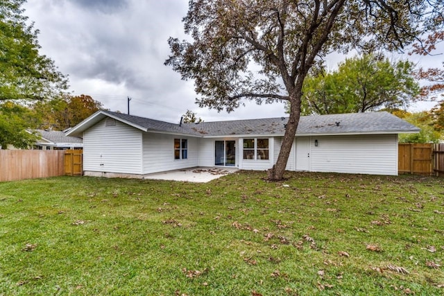 rear view of property with a patio area and a yard