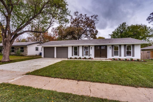 single story home with a garage and a front yard