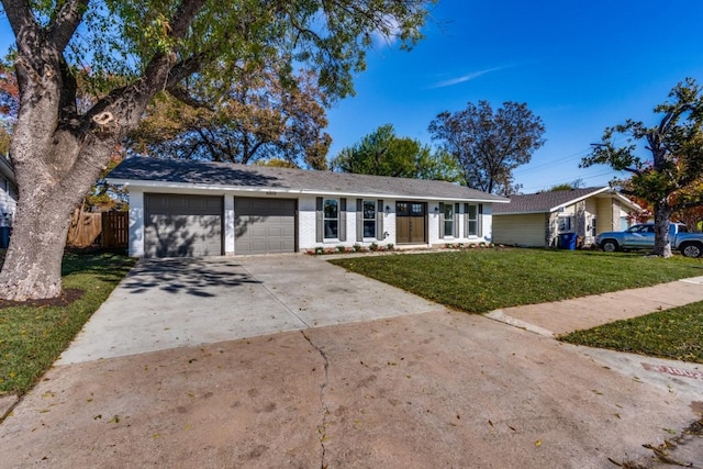 ranch-style home featuring a front yard and a garage