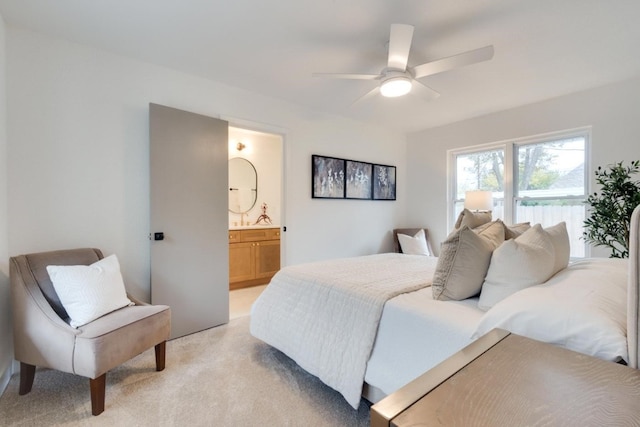 carpeted bedroom featuring ensuite bath and ceiling fan