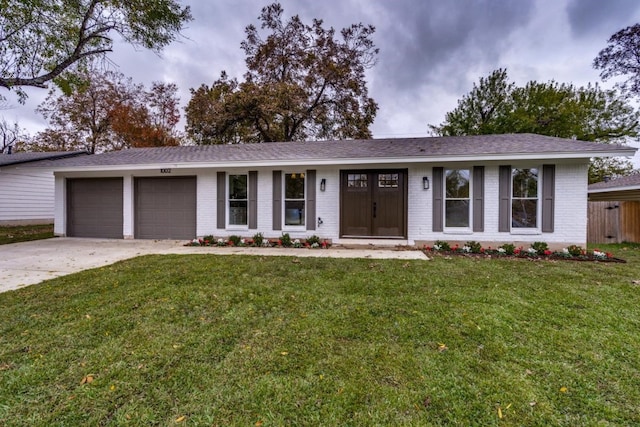 ranch-style house with a garage and a front lawn