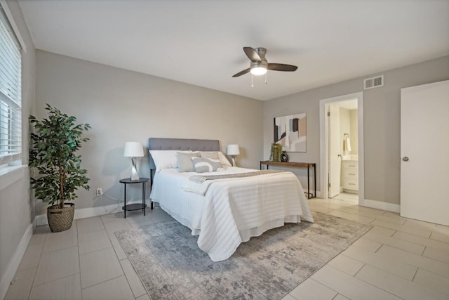 bedroom featuring ceiling fan, light tile patterned flooring, and ensuite bathroom