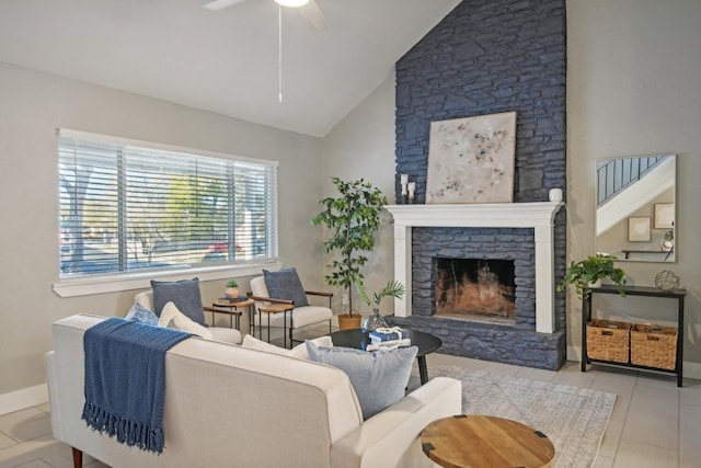 living room with a fireplace, light tile patterned floors, high vaulted ceiling, and ceiling fan