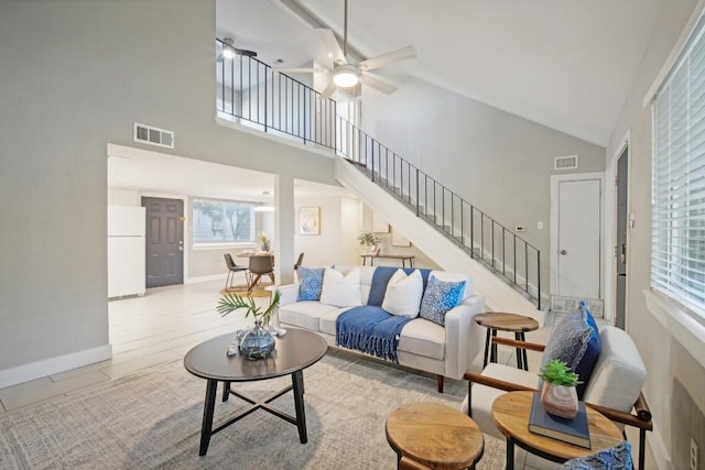 living room with ceiling fan and high vaulted ceiling