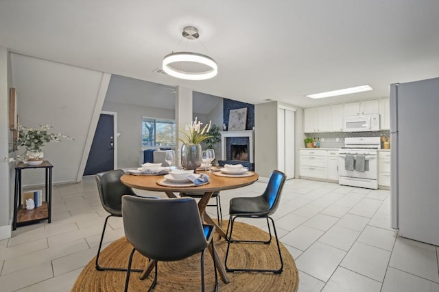 tiled dining area with a fireplace