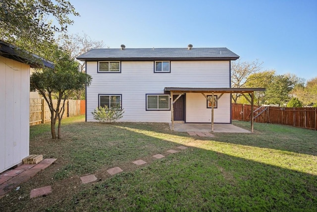 back of house featuring a yard and a patio area