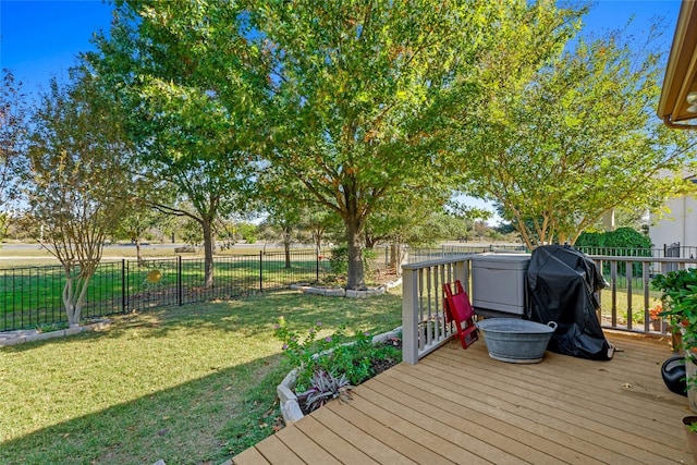 wooden terrace featuring a lawn and area for grilling