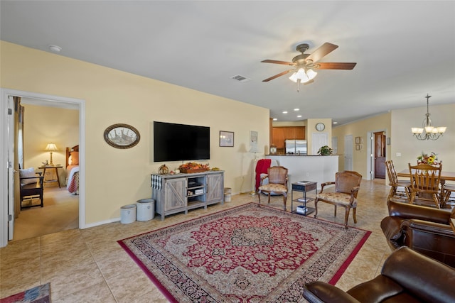 tiled living room with ceiling fan with notable chandelier