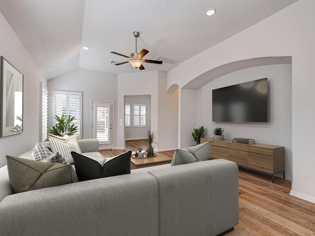 living room featuring ceiling fan, light hardwood / wood-style flooring, and lofted ceiling