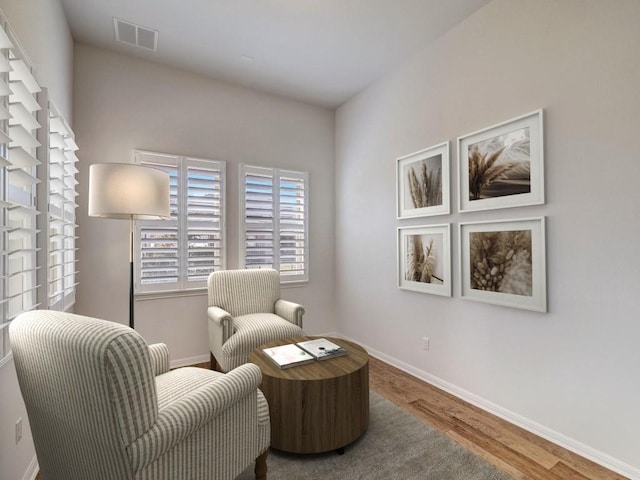 sitting room with wood-type flooring