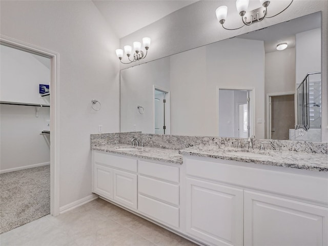 bathroom featuring tile patterned floors, vanity, and vaulted ceiling