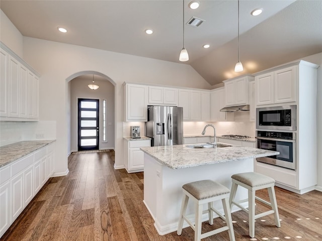 kitchen with white cabinetry, sink, lofted ceiling, and appliances with stainless steel finishes