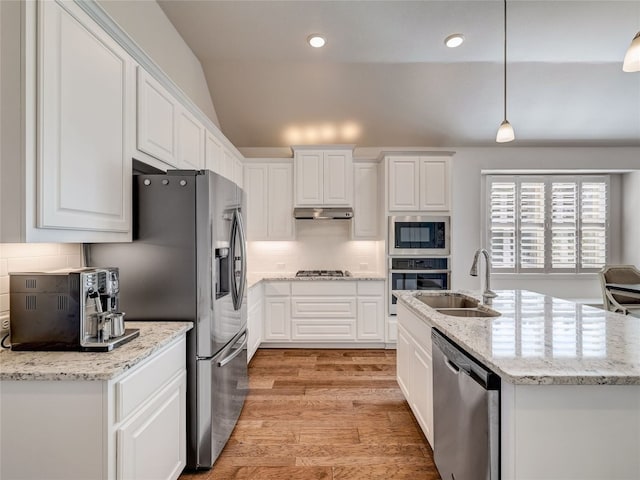 kitchen with stainless steel appliances, white cabinetry, lofted ceiling, and sink