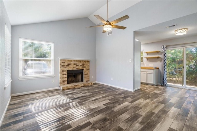 unfurnished living room featuring ceiling fan, a fireplace, high vaulted ceiling, and dark hardwood / wood-style floors