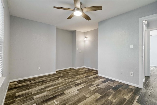 empty room featuring dark hardwood / wood-style floors and ceiling fan