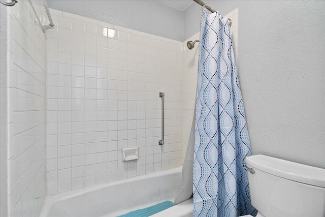 bathroom with shower / bathtub combination with curtain and toilet