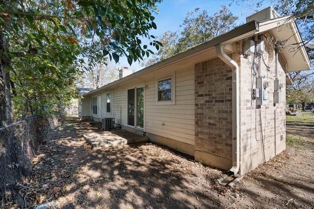 view of side of home featuring cooling unit