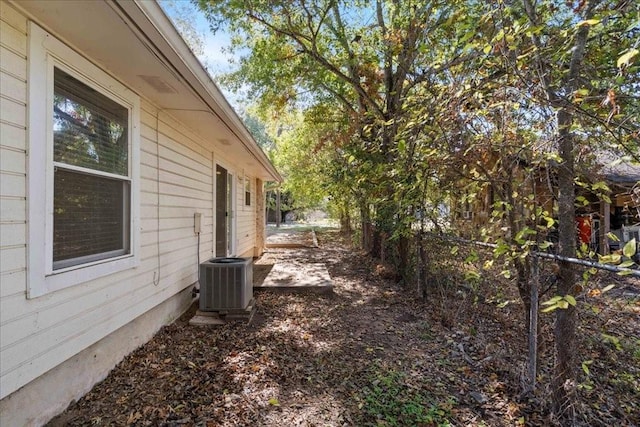 view of side of property with central air condition unit