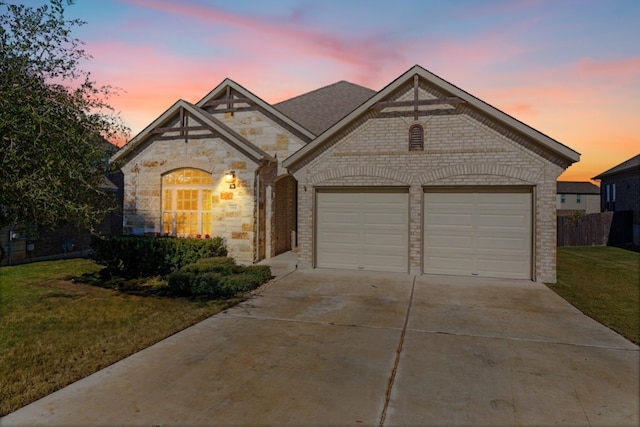 view of front of home with a yard and a garage