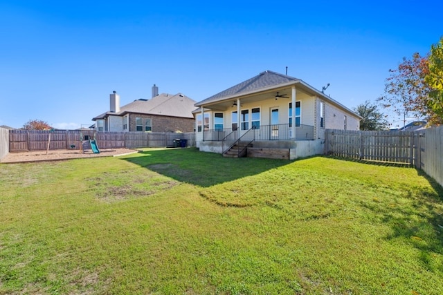 back of house featuring ceiling fan, a yard, and covered porch