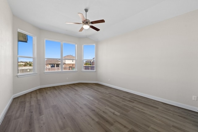 unfurnished room with dark hardwood / wood-style floors and ceiling fan