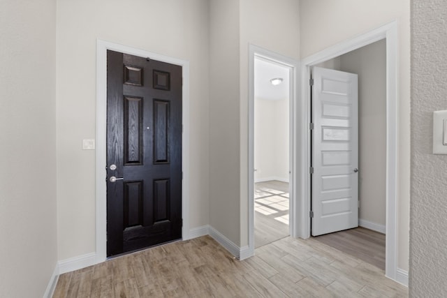 entryway with light hardwood / wood-style floors