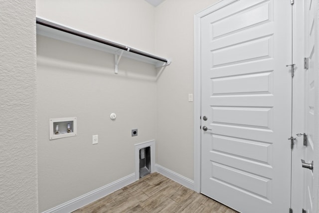 laundry area featuring hookup for an electric dryer, hookup for a washing machine, light hardwood / wood-style floors, and hookup for a gas dryer