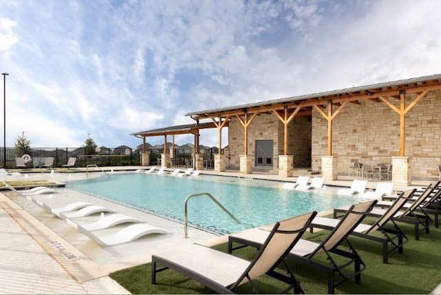 view of swimming pool with a fireplace and a patio