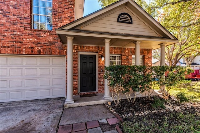 doorway to property with a porch and a garage