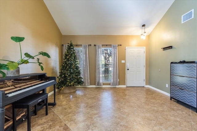 entryway with vaulted ceiling and a notable chandelier