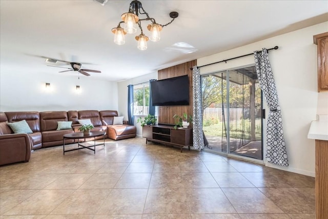 living room with ceiling fan with notable chandelier