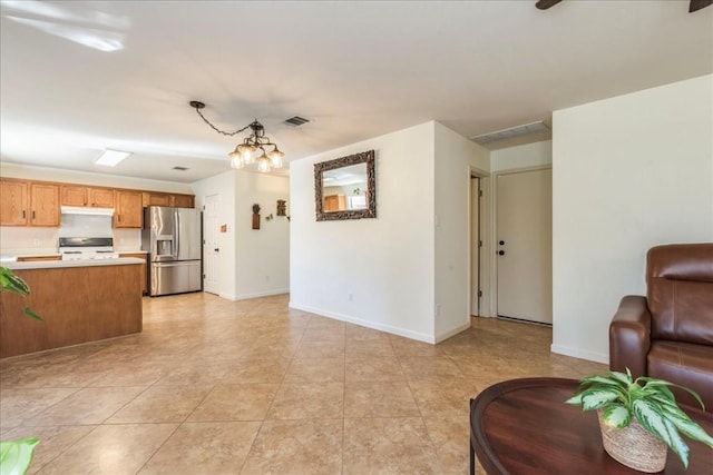 living room featuring light tile patterned floors and a chandelier