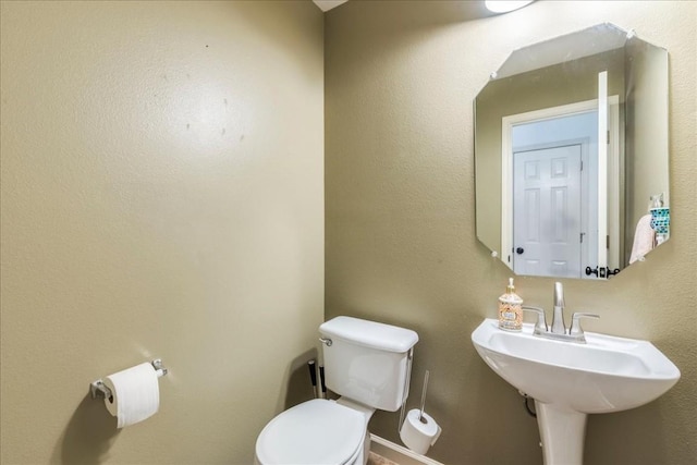 bathroom with toilet and sink