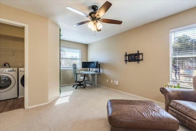 office area with ceiling fan, light colored carpet, separate washer and dryer, and a wealth of natural light