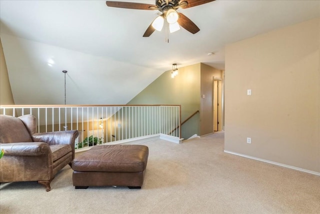 living area featuring light colored carpet, vaulted ceiling, and ceiling fan