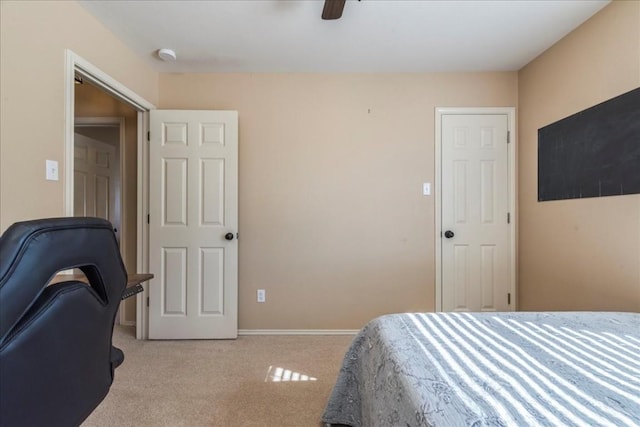 bedroom featuring light carpet, a closet, and ceiling fan