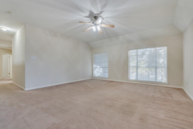 carpeted empty room featuring ceiling fan and lofted ceiling