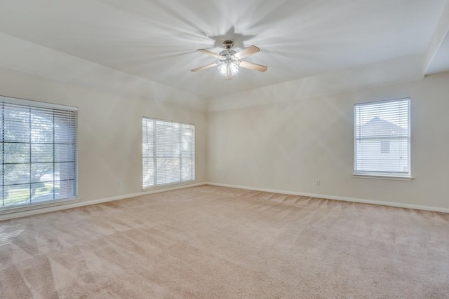 carpeted spare room with ceiling fan