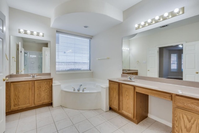 bathroom with tile patterned flooring, vanity, and separate shower and tub