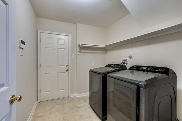 laundry area with washing machine and clothes dryer